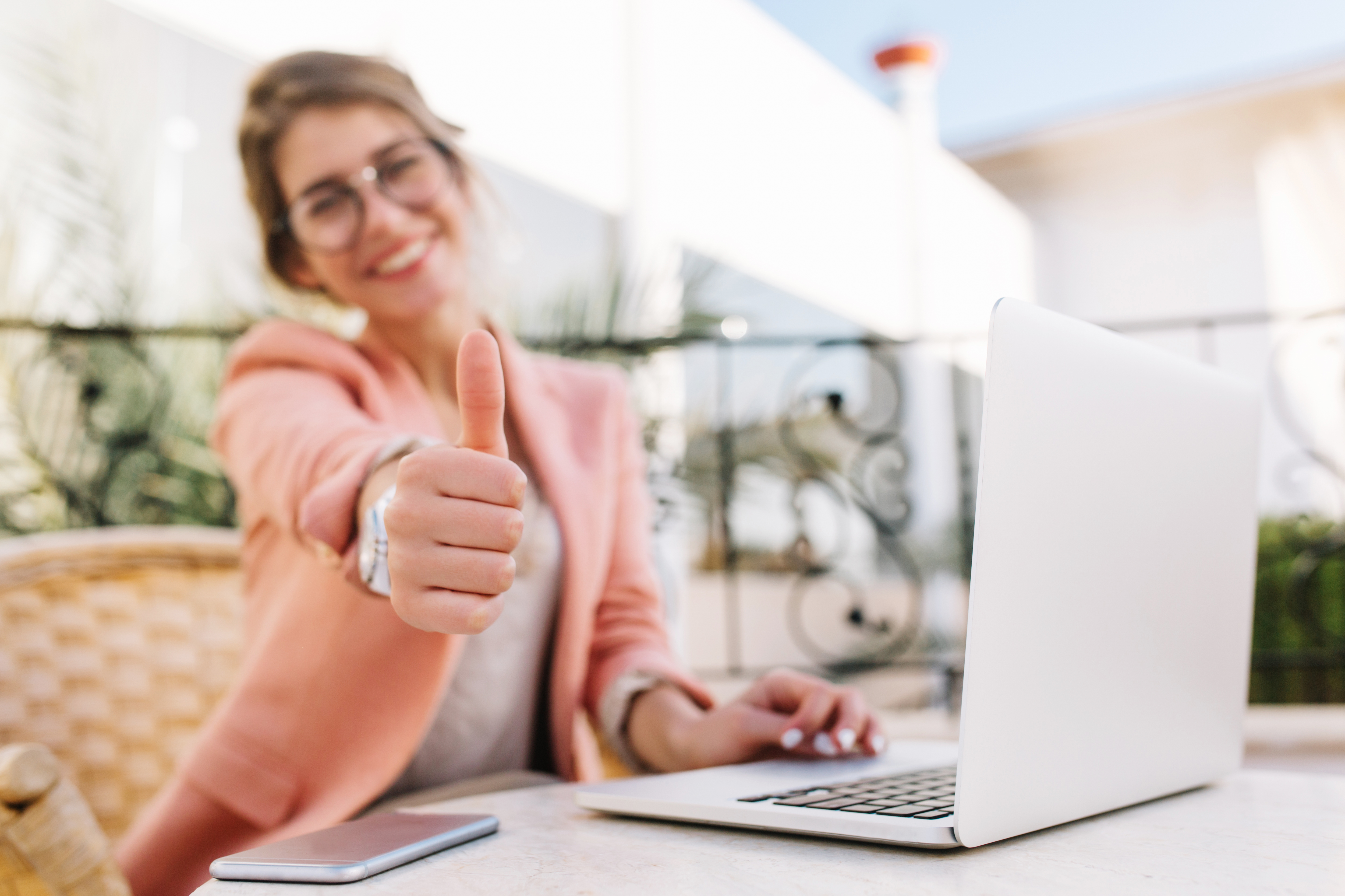 https://4800530.fs1.hubspotusercontent-na1.net/hubfs/4800530/cute-young-woman-student-business-lady-showing-thumbs-up-well-done-sitting-outdoor-cafe-terrace-with-laptop-wearing-pink-smart-clothes.jpg